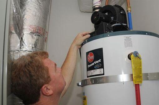 Picture of a plumber doing water heater maintenance